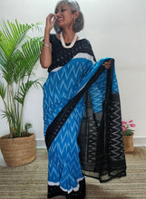 Load image into Gallery viewer, Chanchal, beautiful Ikkat soft cotton saree, blue color with white chevron patterns, black border with motifs, black pallu chevron pattern, office wear, handwoven, casual wear.