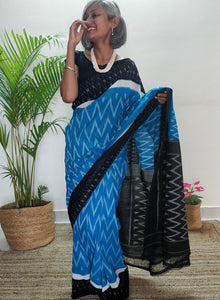 Chanchal, beautiful Ikkat soft cotton saree, blue color with white chevron patterns, black border with motifs, black pallu chevron pattern, office wear, handwoven, casual wear.