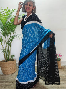 Chanchal, beautiful Ikat cotton saree, blue color with white chevron patterns, black border with motifs, black pallu chevron pattern, office wear, handwoven, casual wear.