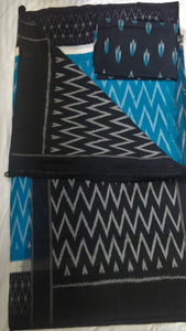 Chanchal, beautiful Ikkat soft cotton saree, blue color with white chevron patterns, black border with motifs, black pallu chevron pattern, office wear, handwoven, casual wear.